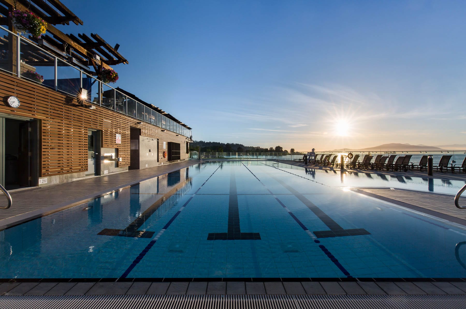Renovated point grey outdoor swimming pool at beautiful sunrise